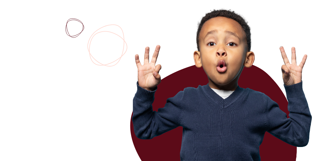 A young boy in a blue sweater making an expressive gesture with both hands raised, against a simple, abstract background with circular designs.