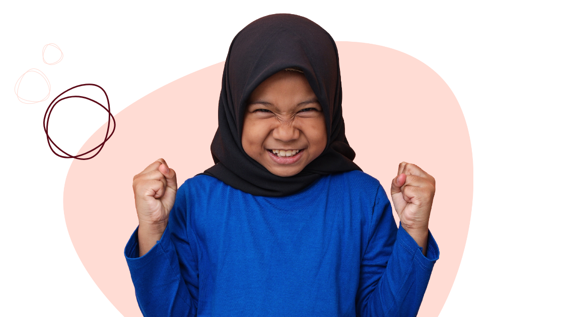 Child wearing a black headscarf and blue shirt, smiling broadly with clenched fists, in front of a pink background with circular designs.